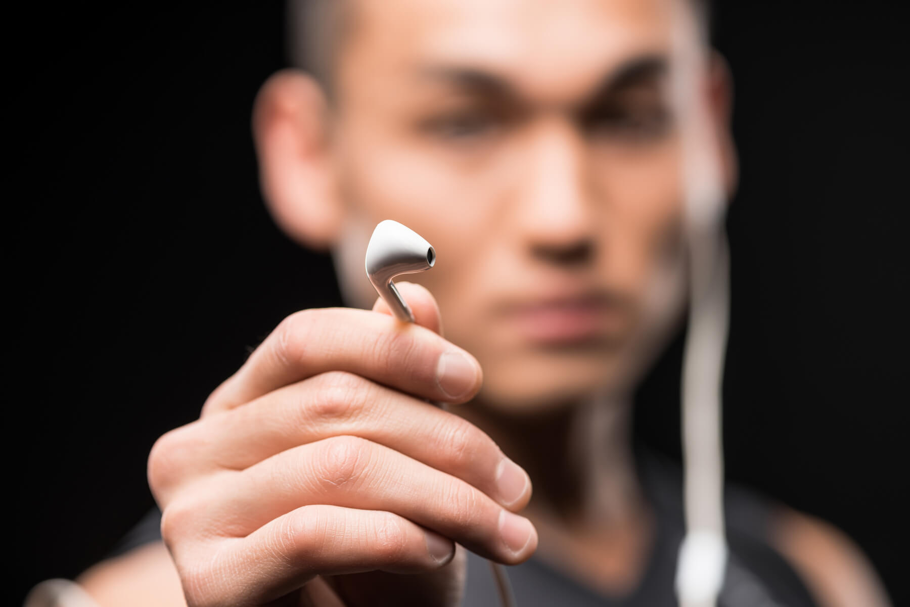 Close Up View Of Young Man Holding Earphones Isola 2023 11 27 04 55 06 Utc